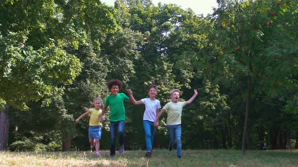 Multi-Racial Group of Friends Running Grass Holding Hands, Mates Connection, Fun