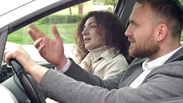 A Man and a Woman Sitting in the Car are Quarreling alt