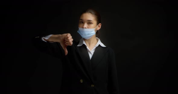 Brunette Shows How to Properly Put on a Medical Mask and Gives a Thumbs Up