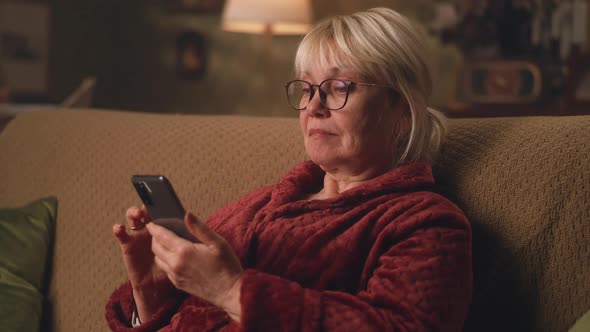 Aged Woman Chatting on Smartphone alt