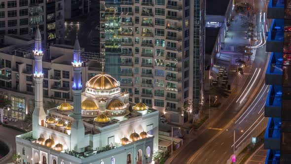 Modern Residential Architecture of Dubai Marina and Mohammed Bin Ahmed Almulla Mosque Aerial Night alt