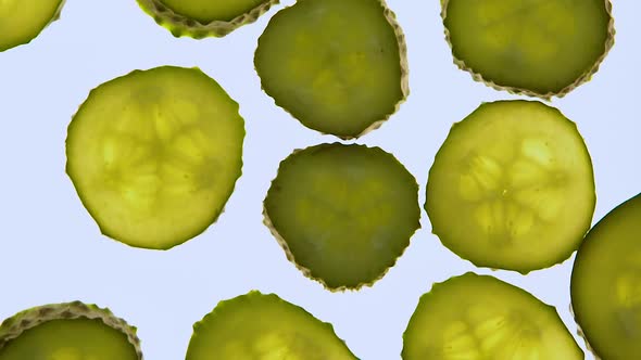 Fresh Cucumbers Spinning on White Background, Low-Calorie Vegetarian Food alt