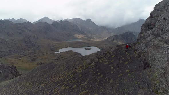 Mountain Climbing man Lakes and Clouds