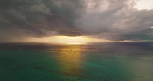 Scenic Aerial View of the Sun Rising Behind Le Morne Mountain alt