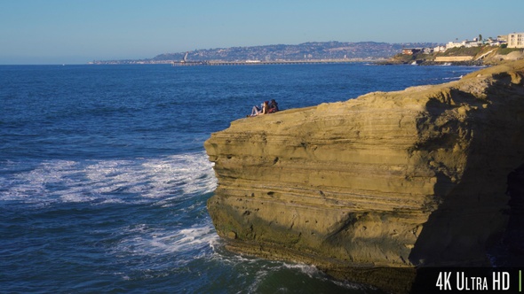 4K Relaxing Couple on Steep Waterfront Cliff Waiting for the Sunset in San Diego, CA
