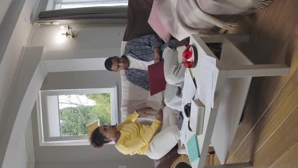 Vertical Video of Irritated Annoyed African American Woman Arguing with Busy Man Typing on Laptop alt