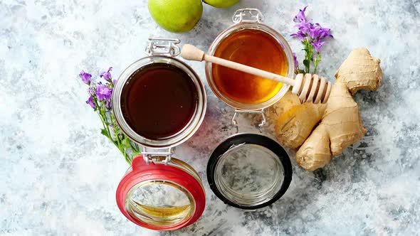 Healthy Food Table with Different Kinds of Honey, Fresh Ginger and Lime alt