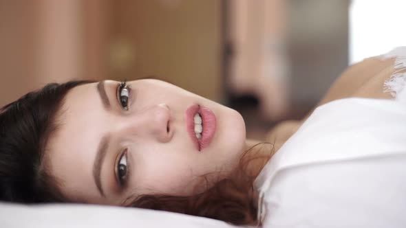 Portrait of a Sexy Relaxed Woman in Lingerie Lying on the Bed alt