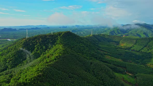 Drone flying over over telecommunication towers on green mountain alt