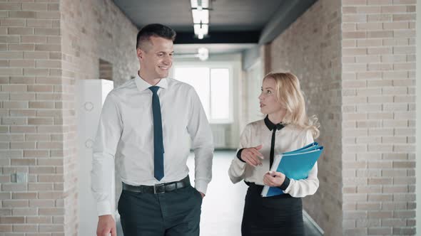 Co Workers Walks in the Building alt