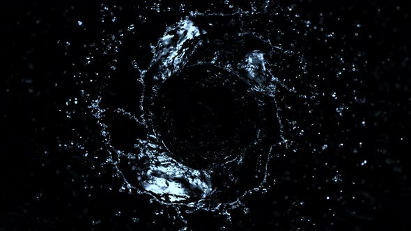 Super Slow Motion Shot of Rotating Water Splash Isolated on Black Background at 1000Fps alt