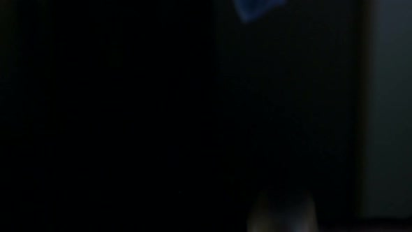 Bottle with Yellowred Pills Fall on Black Table alt