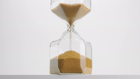 Closeup of a Sand Clock in Studio. Minimalistic Video About Time Concept