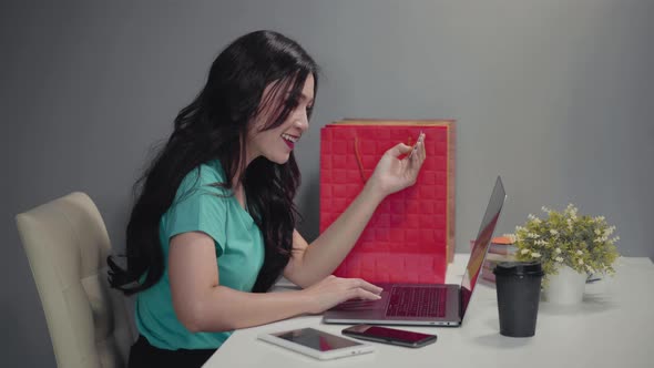 happy woman using laptop computer for online shopping with credit card