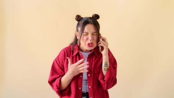 Angry woman in rage screams and yells into phone, quarrels gesturing emotionally. Bad feedback alt
