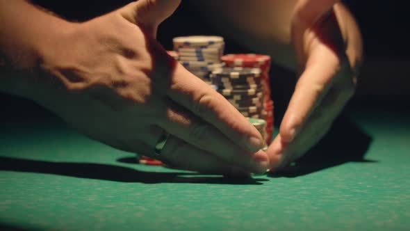 Croupier Moves Chips On Table At Casino. alt