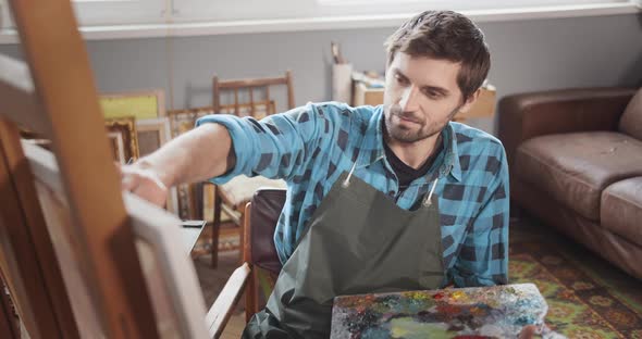 Bearded Male Artist Painting in Studio Portrait