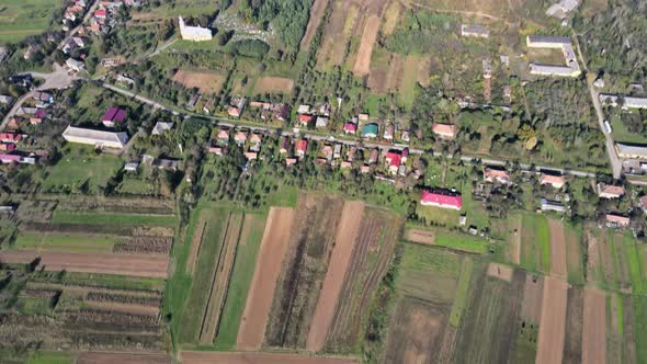 Aerial Panorama in Springtime Field on Hillside Mountains Near Village in Wonderful Landscape alt