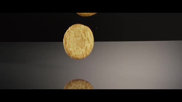 Falling cookies from above onto a reflective surface alt