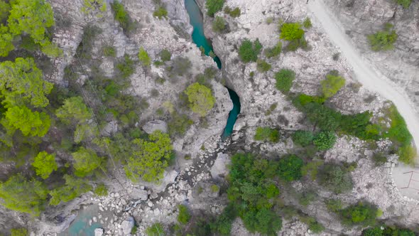 Flight Over a Mountain River and a Trail to a Gorge Among a Coniferous Forest alt