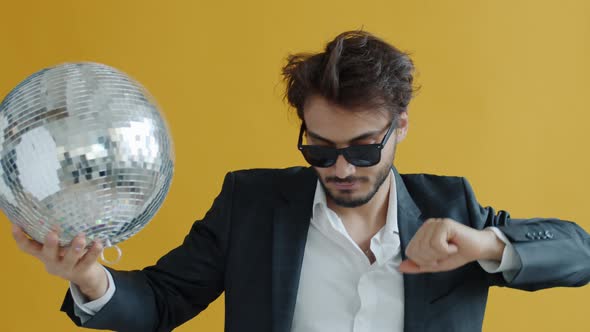 Portrait of Arab Businessman Dancing with Discoball Having Fun Clubbing alt