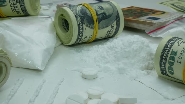Illegal Money Profit of the Drug Cartel from the Sale of Cocaine and Tablets alt