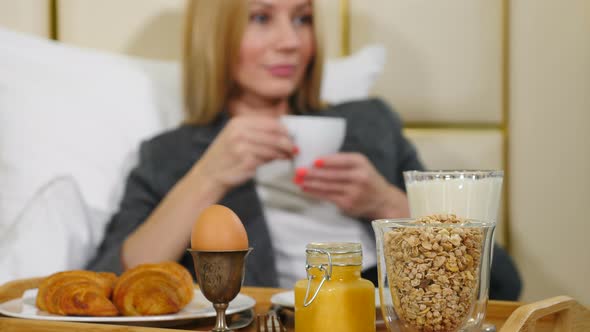 Young Pretty Successful Business Woman Having Breakfast in Luxury Hotel Room alt