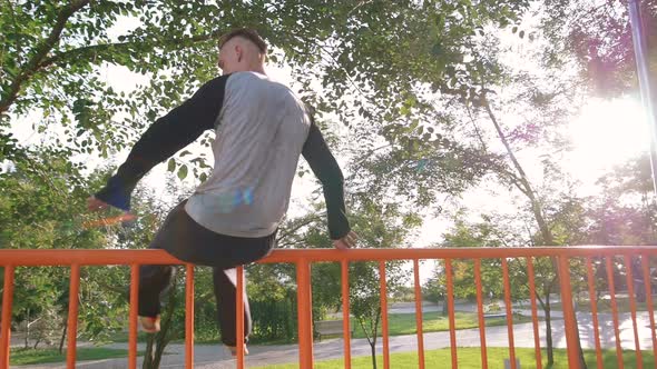 Young Man Doing Parkour Tricks in Extreme Sports Park alt