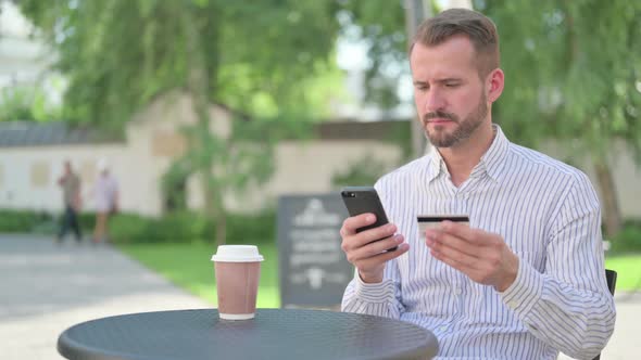 Middle Aged Man with Unsuccessful Online Payment on Smartphone alt