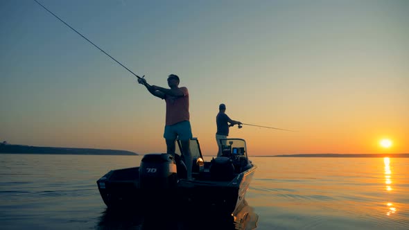Men Are Catching Fish From an Autoboat in the Open Water alt