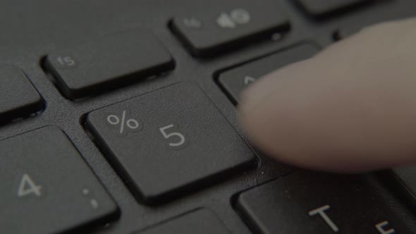 The Finger Presses a Button with a Number on the Keyboard alt