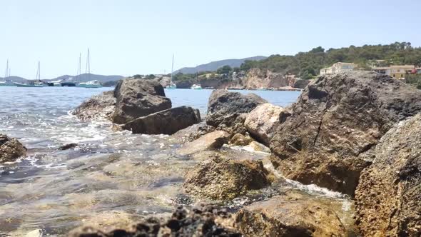 Sea waves crash against the rocky shore. Tourist destination at sea. alt