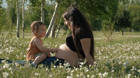 Slow Motion of Young Pregnant Woman Shows Belly To Her Son