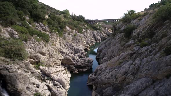 Aerial View of an Ancient Stone Bridge Called Devil's Bridge in South of France alt