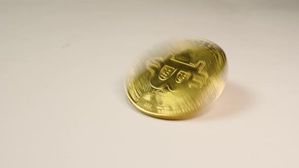 Bitcoin cryptocurrency gold coin - BTC - Bit Coin spins on a white background alt