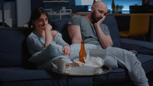 Depressed Frustrated Young Couple Sitting in Couch Suffering From Insomnia alt