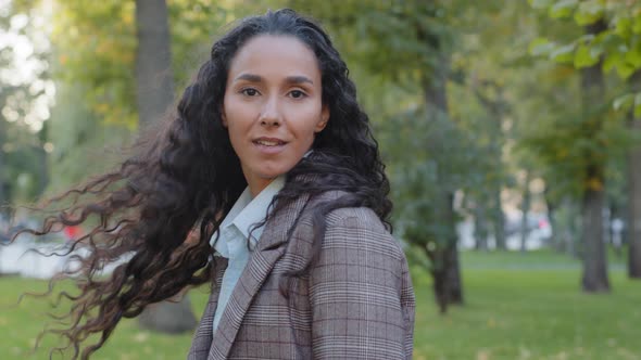 Back View Portrait Young Beautiful Brunette with Gorgeous Curly Long Hair Stylish Hairstyle Turns alt