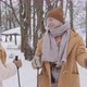 Young Couple with Ski Poles in Winter Forest - VideoHive Item for Sale
