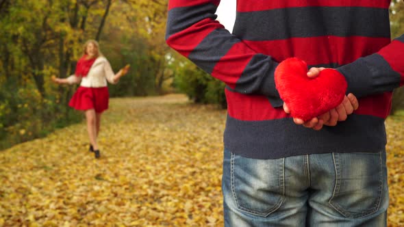 Couple Dating In Park, Guy Hiding Heart For Girlfriend