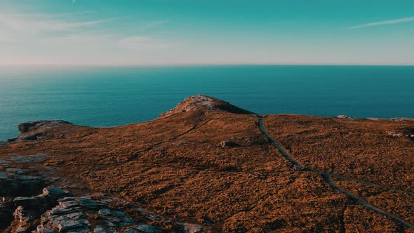 Monument to King Arthur in Britain Aerial view of a rock on a background of the sea