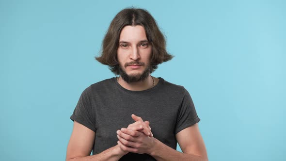 Portrait of Concentrated Hairy Guy in Casual Gray Tshirt with Brooding Look Thinking Hard or alt