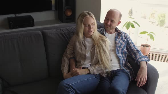 Couple Spending the Time at Home Playing Guitar alt