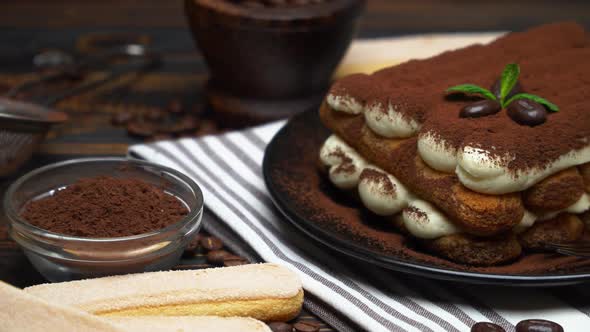 Classic Tiramisu Dessert and Savoiardi Cookies on Ceramic Plate on Concrete Background