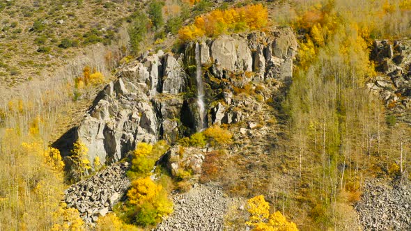 Aerial View Over the Waterfall on the Rocky Cliff. Yellow Trees Are Around. Fall Season alt