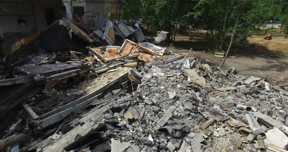 A Vertical Inspection of a Half Demolished Building Next To Its Ruined Parts alt