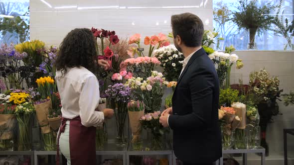 Florist Selecting Flowers for Bouquet with Client alt