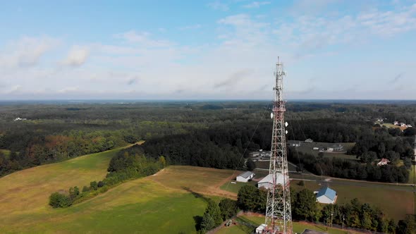 Cell phone tower in rural country setting orbiting drone. alt