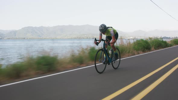 Tracking shot of a female cyclist on country road.  Fully released for commercial use.