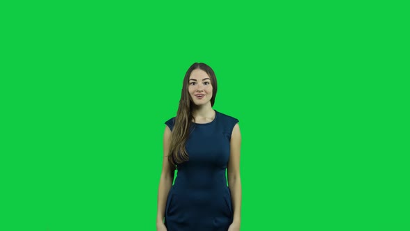Sexy attractive girl cheering in front of a green screen alt