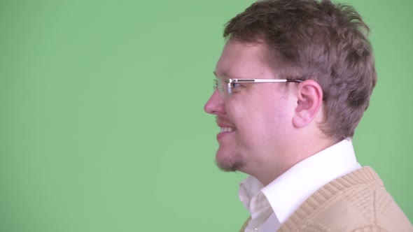 Closeup Profile View of Happy Overweight Bearded Man Smiling alt